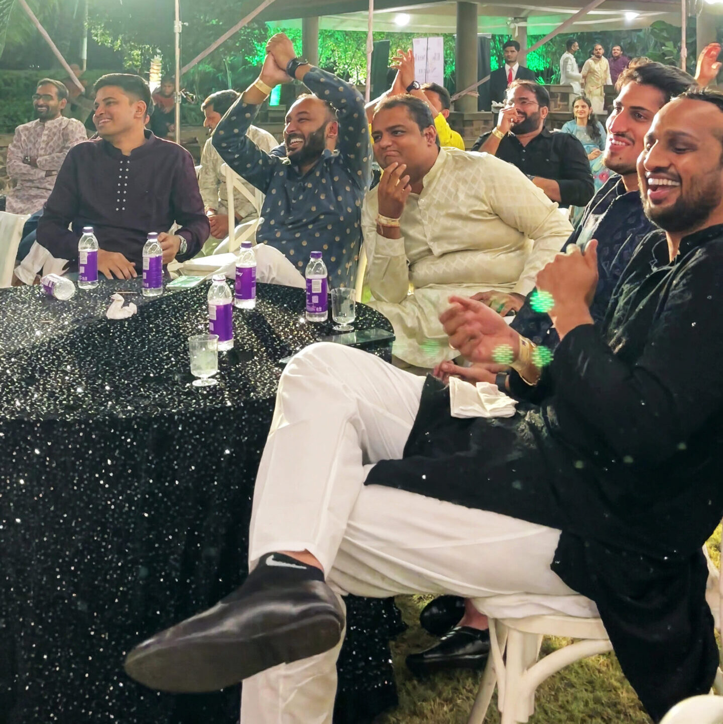 Wedding Magician & Mentalist entertains a crowd seated at a table